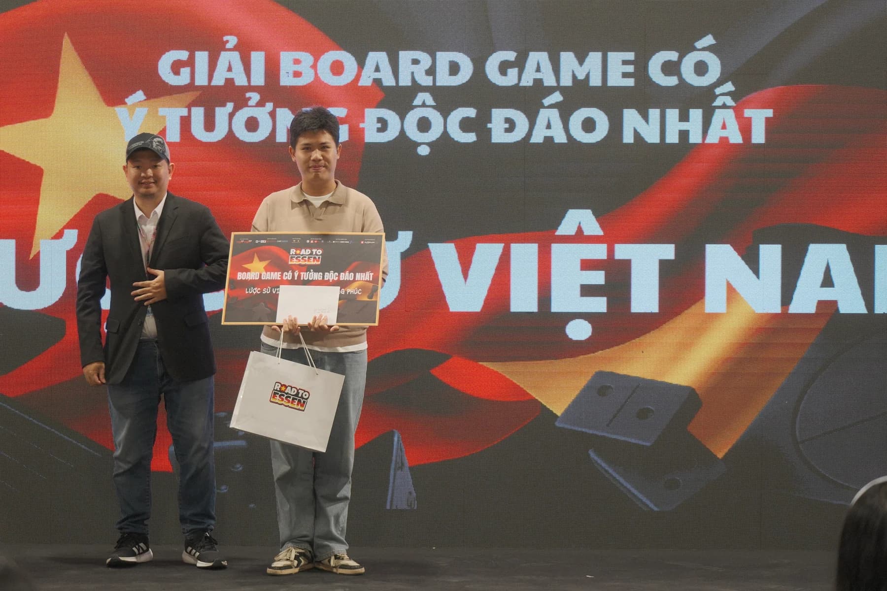 Road to Essen award winner holding the winning board